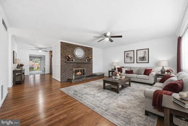 341 Dameron Street South Laurel, MD 20724 - Photo 4 of 32 a living room with fireplace furniture and a wooden floor