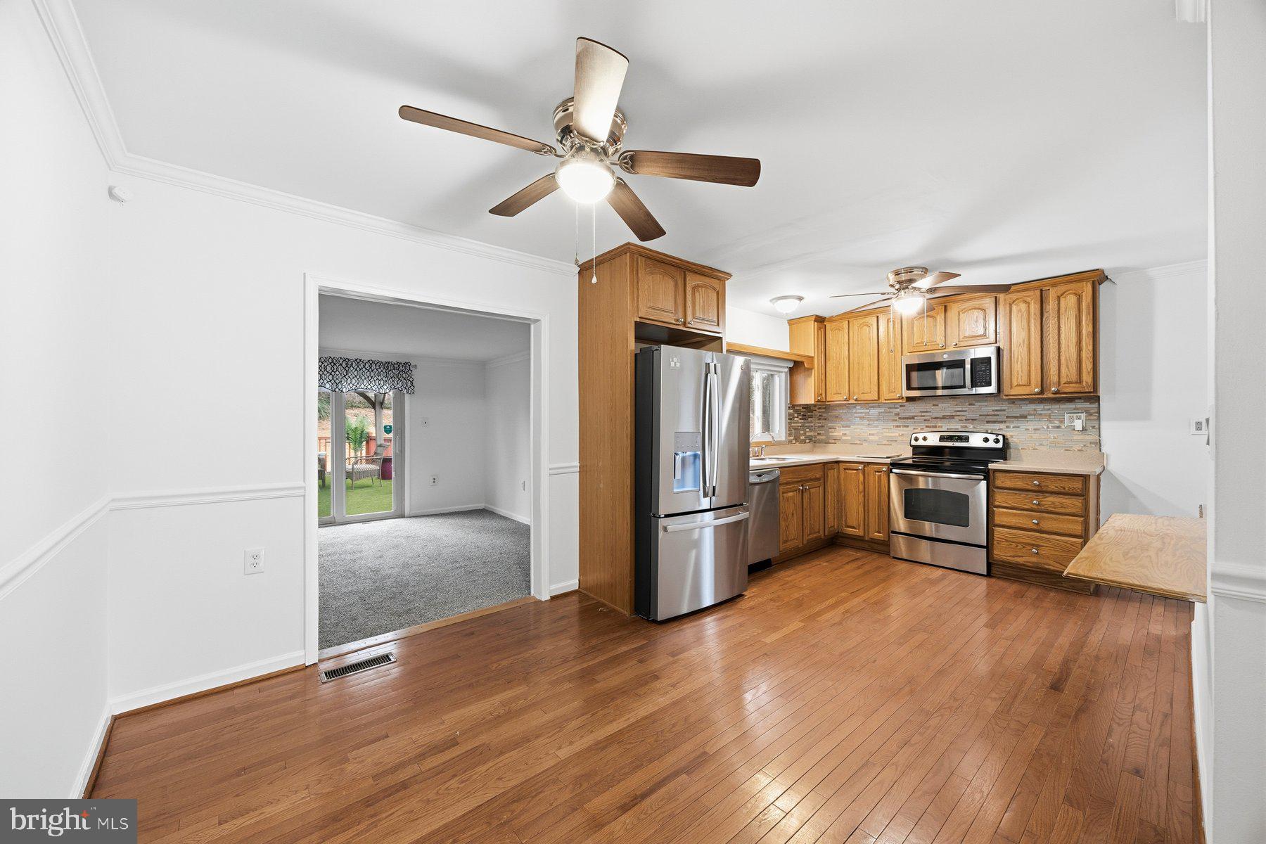 341 Dameron Street South Laurel, MD 20724 - Photo 6 of 32 a kitchen with stainless steel appliances a refrigerator and a stove top oven