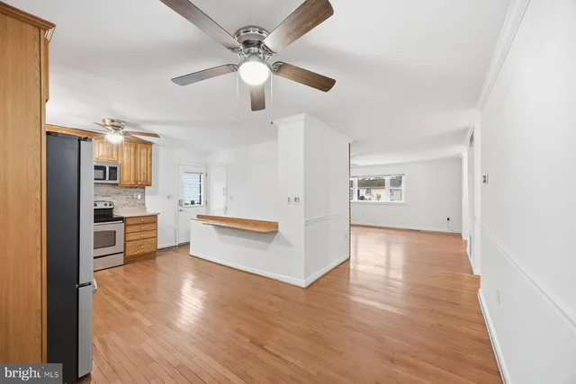 a view of kitchen with cabinets and wooden floor
