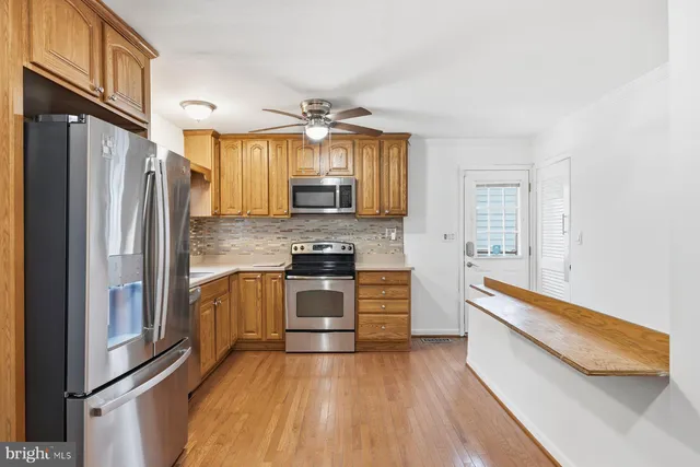 a kitchen with stainless steel appliances a refrigerator sink and stove