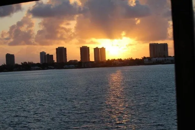 a buildings with car parked in front of it