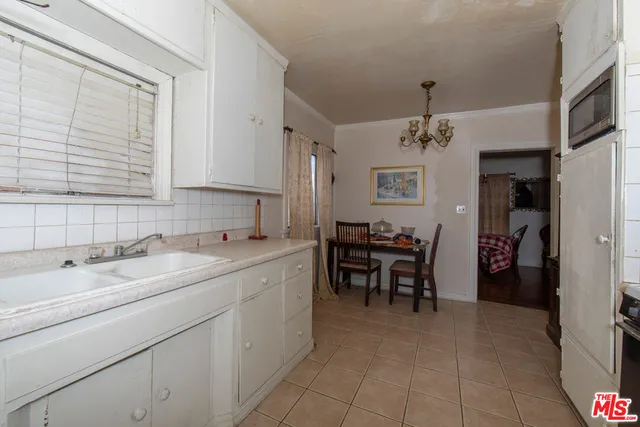 a kitchen with stainless steel appliances a refrigerator and a stove top oven