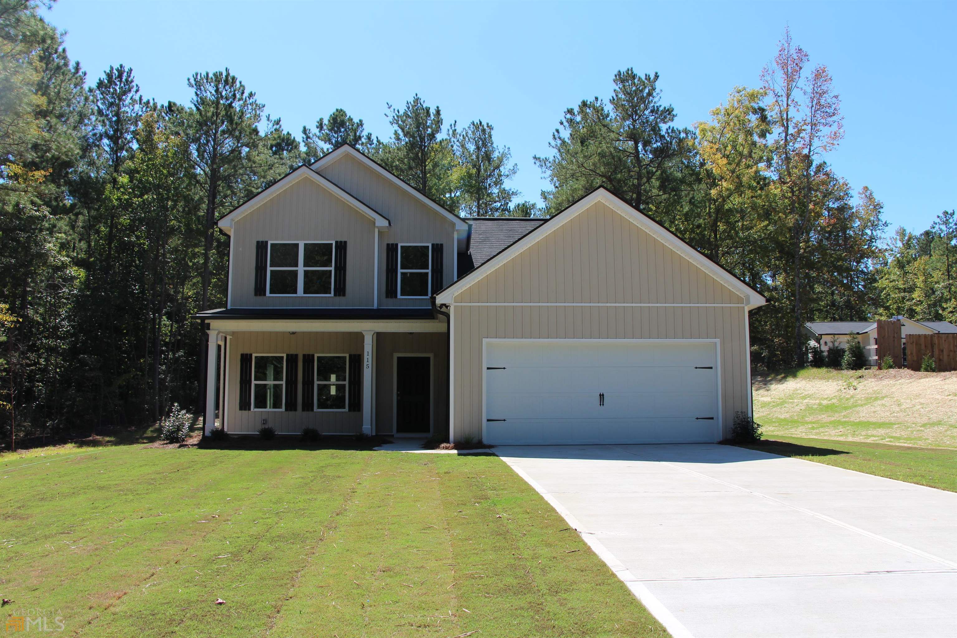 115 Avalee Road Brooks, GA 30205 - Photo 1 of 1 a front view of a house with a yard and garage