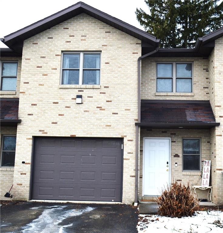 a front view of a house with garage