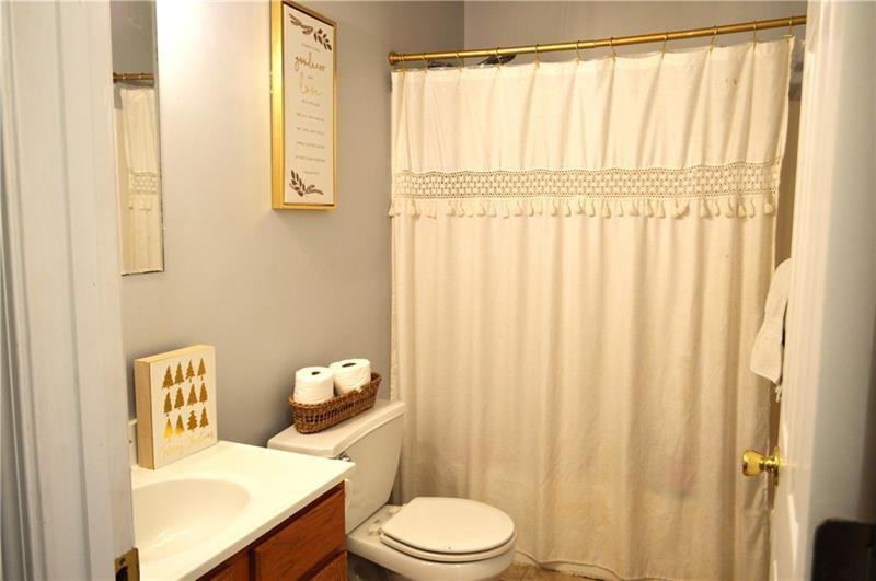 106 Meadowview Drive Renfrew, PA 16053 - Photo 16 of 17 a white toilet sitting next to a bathroom sink and a window