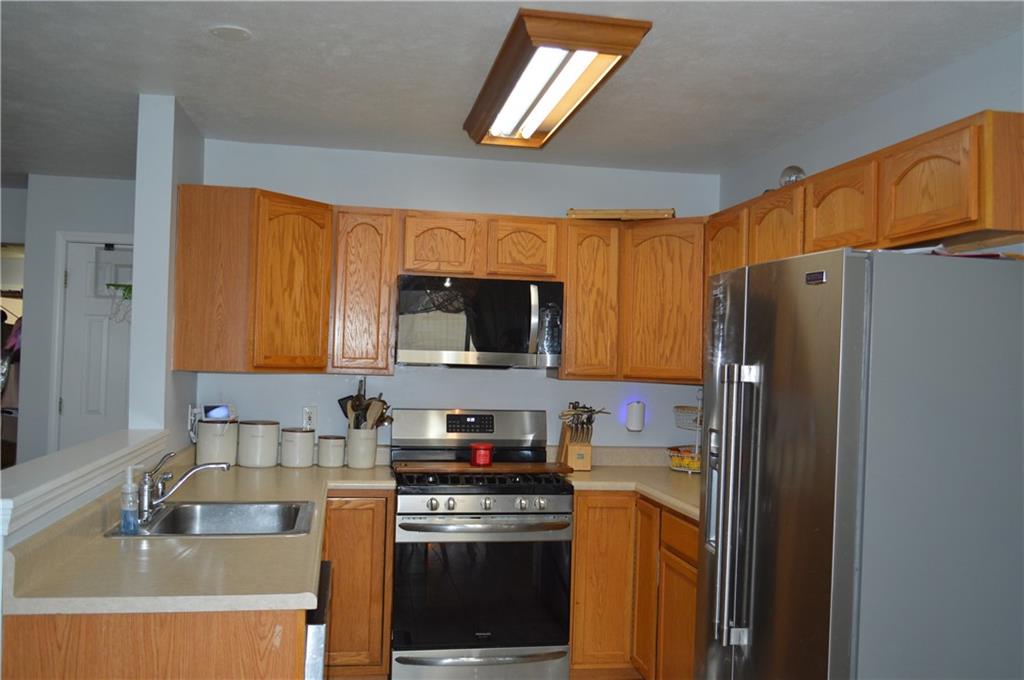 106 Meadowview Drive Renfrew, PA 16053 - Photo 5 of 17 a kitchen with stainless steel appliances granite countertop a refrigerator a stove top oven a sink and dishwasher