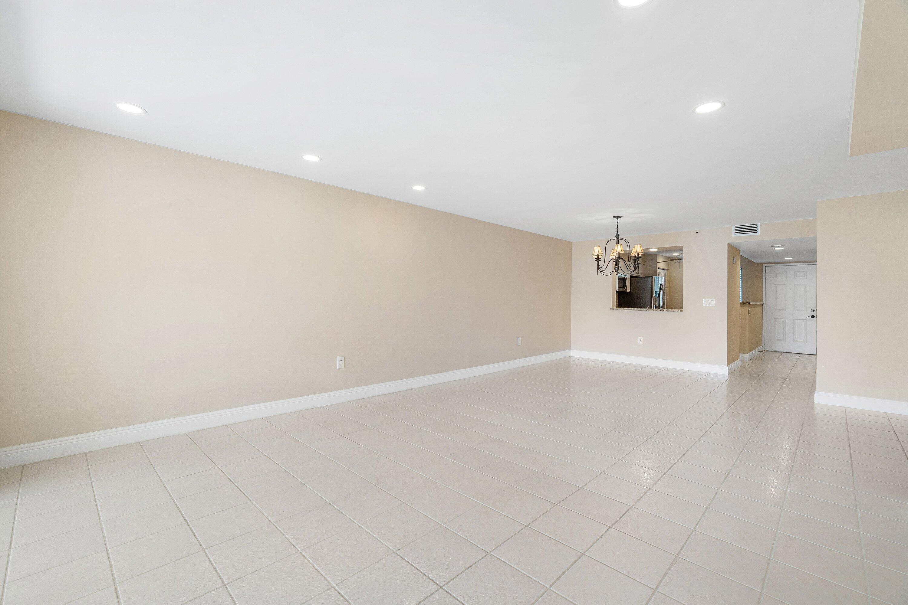 14096 Huntington Pointe Drive, Unit 106 Delray Beach, FL 33484 - Photo 14 of 47 a view of a kitchen with a sink and a refrigerator
