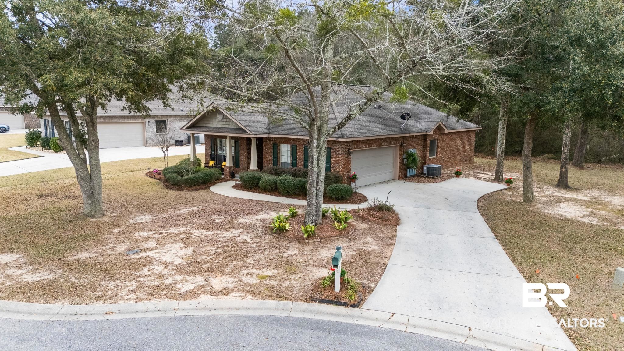 1090 Melbourne Court Foley, AL 36535 - Photo 5 of 38 View of front of property featuring driveway, a porch, brick siding, a garage, and a shingled roof