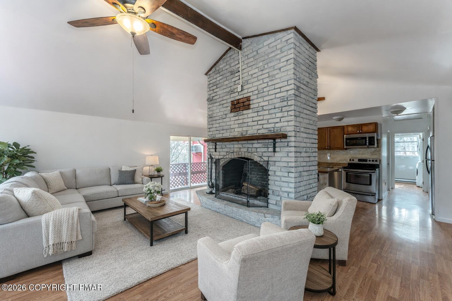 a living room with furniture a flat screen tv and a fireplace
