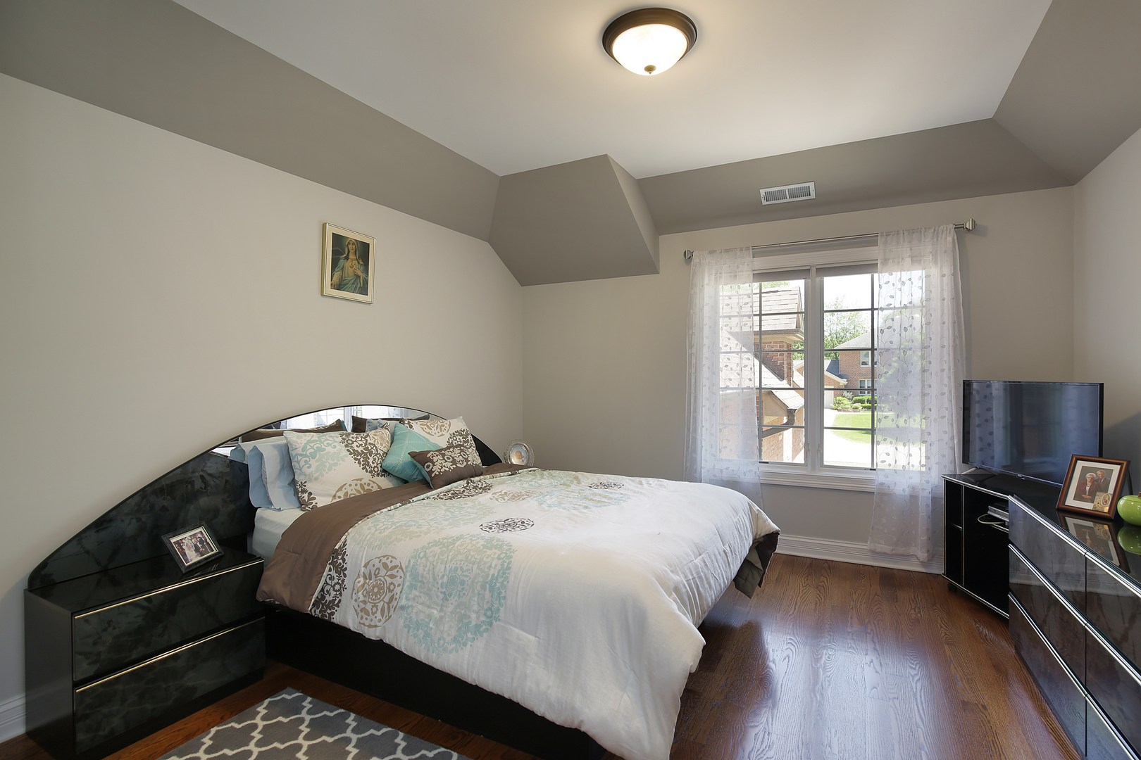 608 Revere Road Glenview, IL 60025 - Photo 18 of 34 a bed sitting in a bedroom next to a window