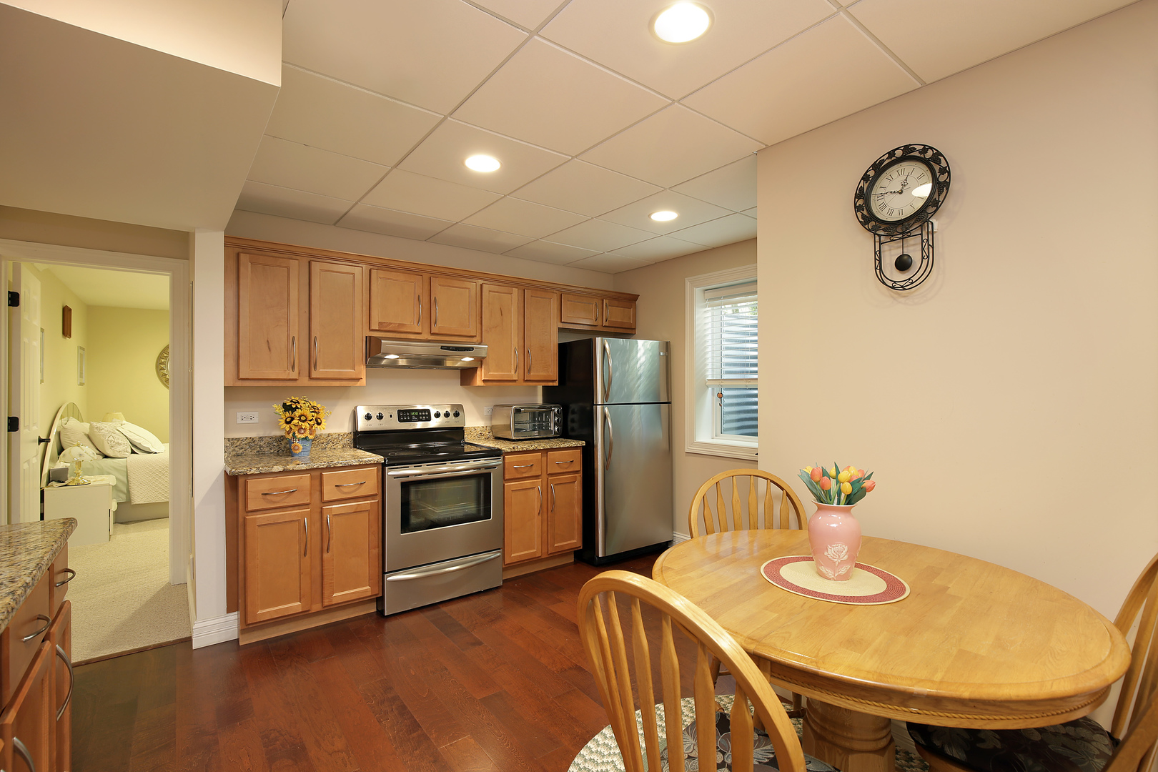 608 Revere Road Glenview, IL 60025 - Photo 24 of 34 a kitchen with stainless steel appliances granite countertop a stove a sink dishwasher a refrigerator with a dining table and chairs