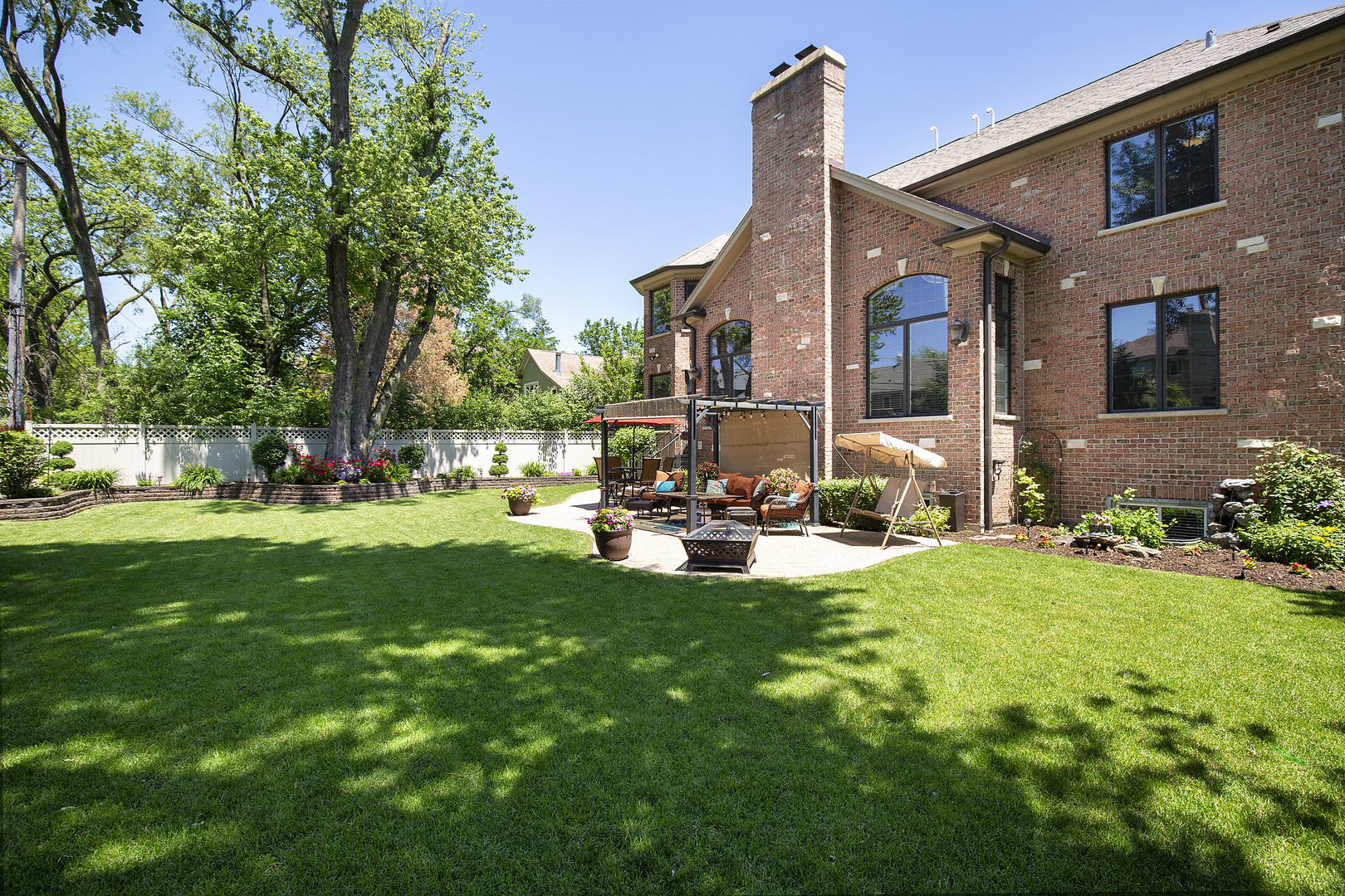 608 Revere Road Glenview, IL 60025 - Photo 27 of 34 a view of a house with backyard sitting area and garden