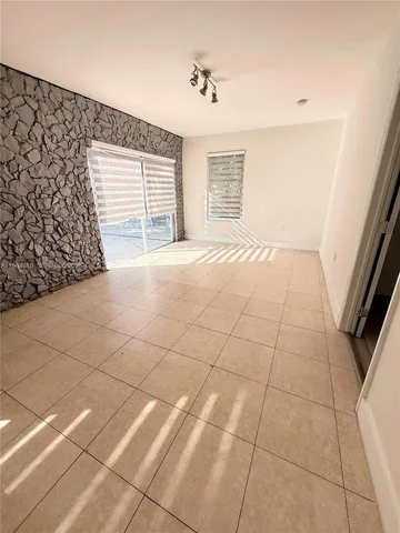 a kitchen with white cabinets a sink and white appliances