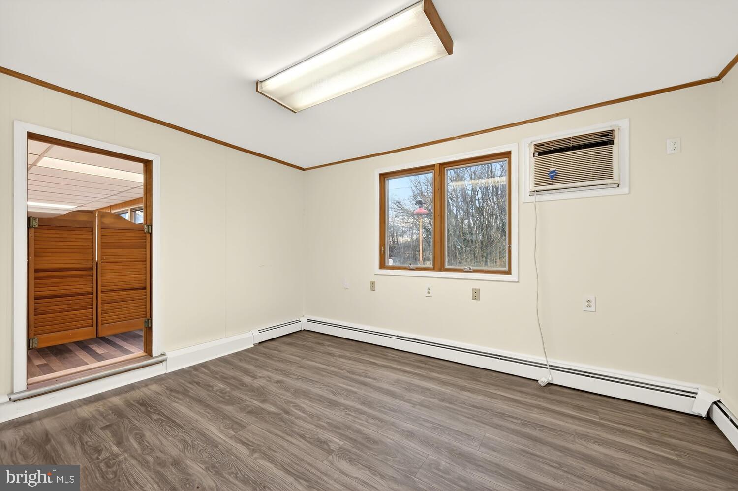6746 Quaker Neck Road Chestertown, MD 21620 - Photo 26 of 50 an empty room with wooden floor and windows