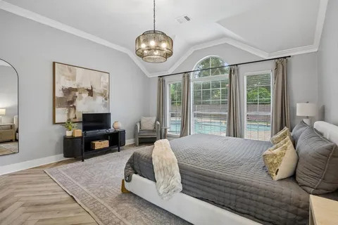 a bed room with a bed mirror and a window