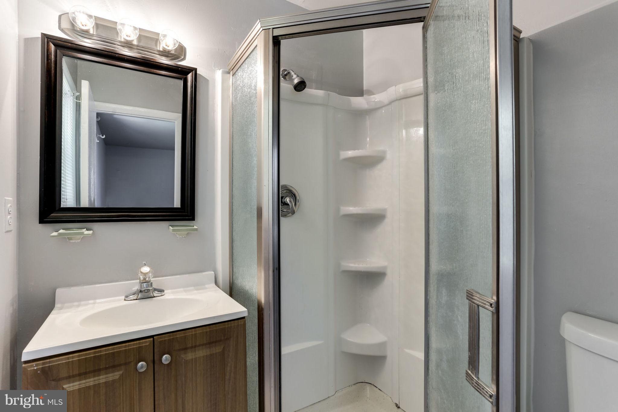 8806 Selina Road Randallstown, MD 21133 - Photo 14 of 30 a bathroom with a toilet sink vanity and mirror