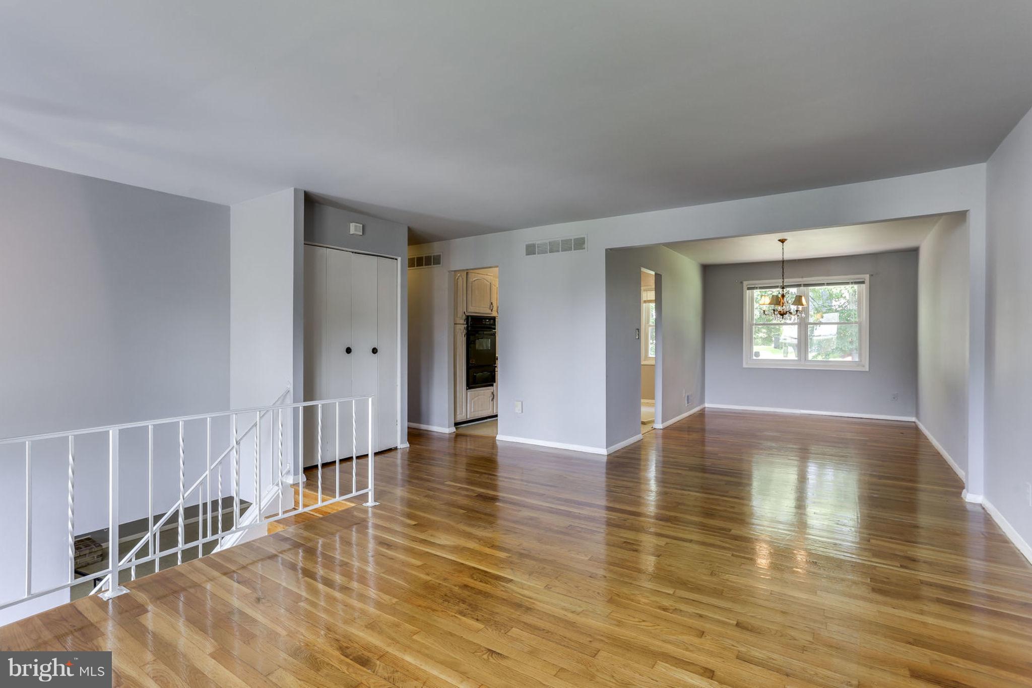 8806 Selina Road Randallstown, MD 21133 - Photo 3 of 30 a view of an empty room with wooden floor and a window