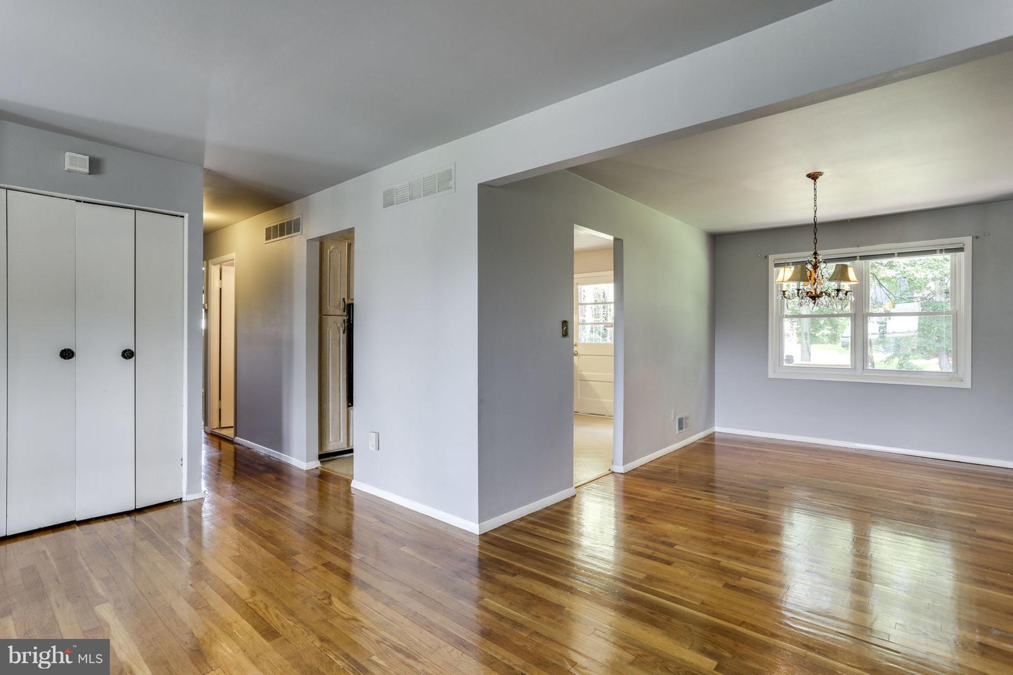 8806 Selina Road Randallstown, MD 21133 - Photo 7 of 30 a view of an empty room with window and wooden floor