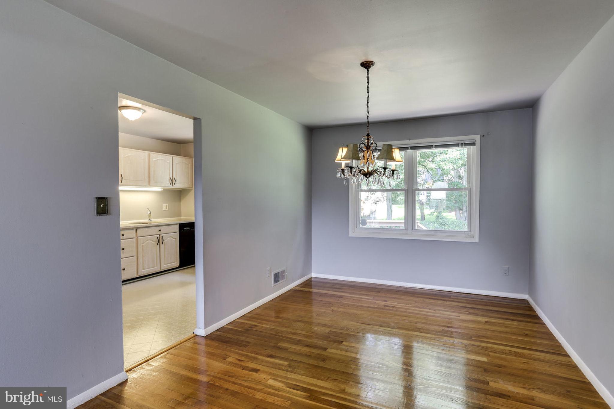 8806 Selina Road Randallstown, MD 21133 - Photo 8 of 30 a view of an empty room with window and wooden floor