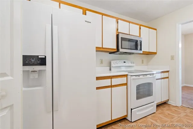a kitchen with stainless steel appliances a stove microwave and sink