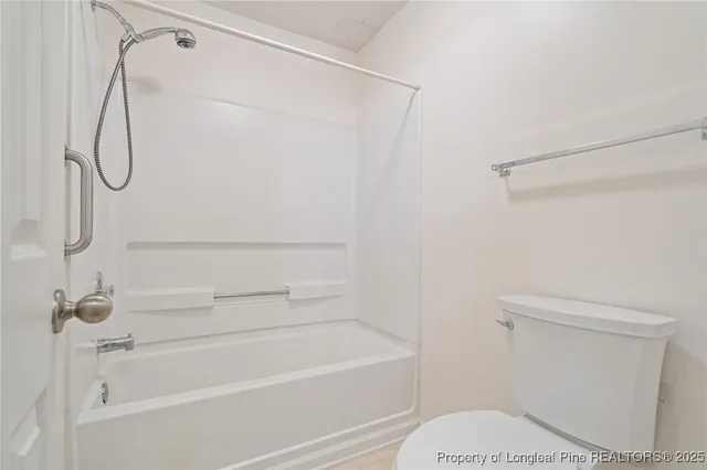 a bathroom with a shower a toilet and a shower