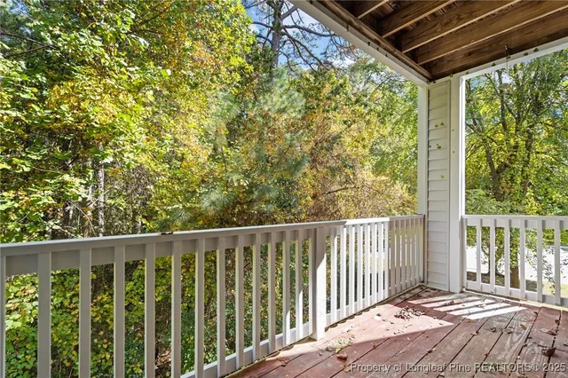 a balcony with trees in front of it