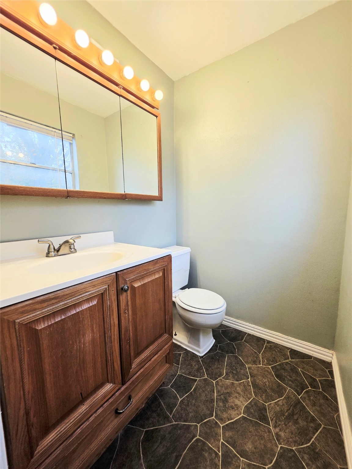 111 South Harvey House Road Somerville, TX 77879 - Photo 12 of 22 a bathroom with a toilet a sink and mirror