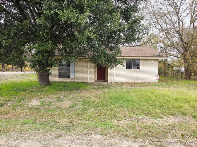 a front view of house with yard and trees