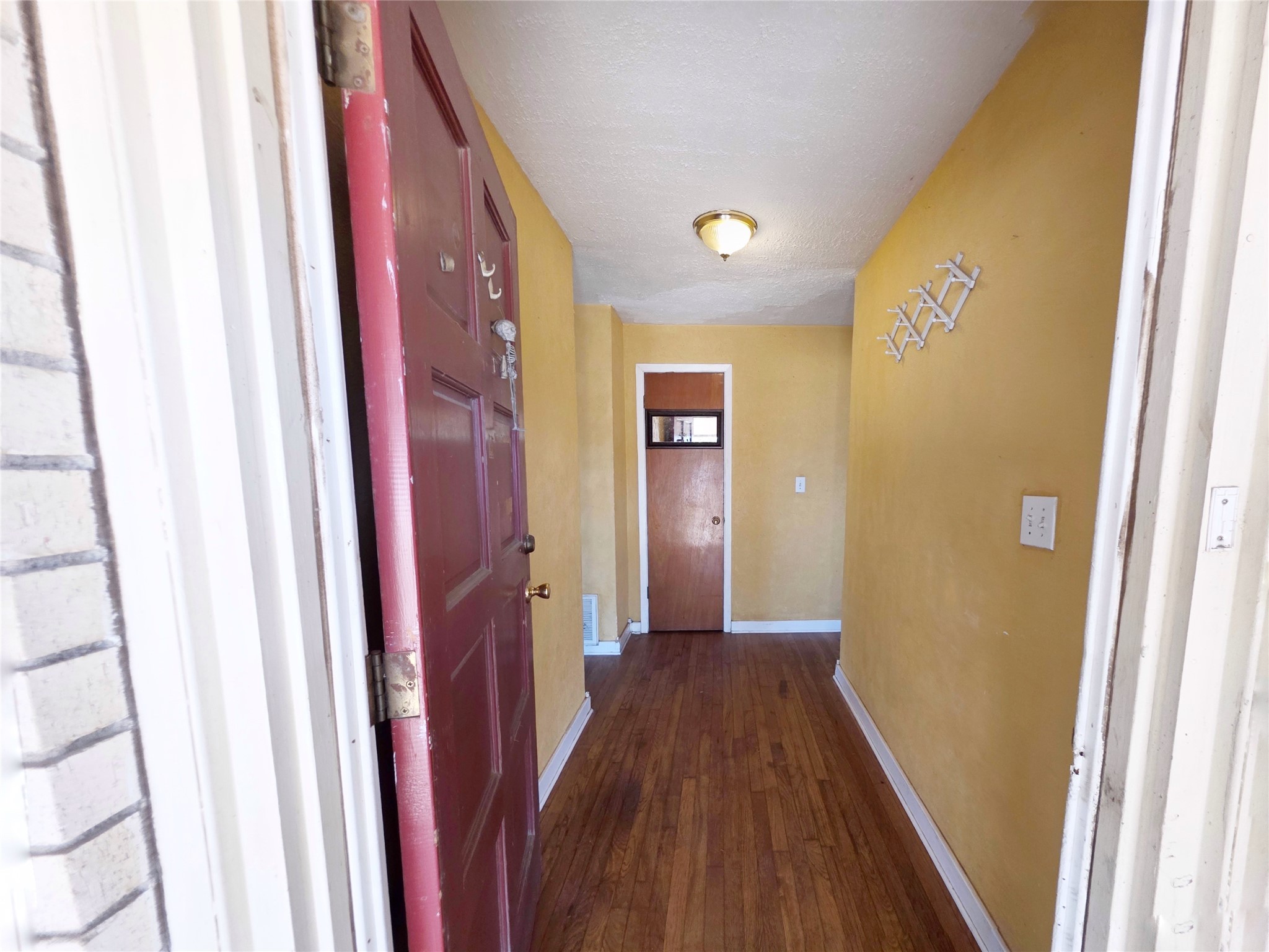 111 South Harvey House Road Somerville, TX 77879 - Photo 4 of 22 a view of a hallway with wooden floor and staircase