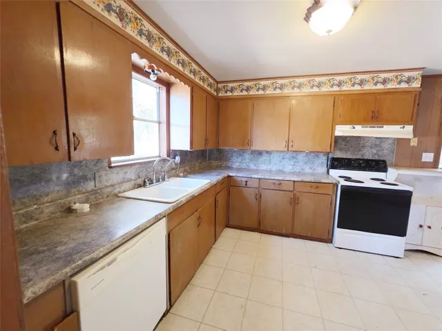 a kitchen with stainless steel appliances granite countertop a sink stove and cabinets