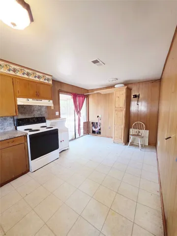 a large bedroom with a bed and a flat screen tv