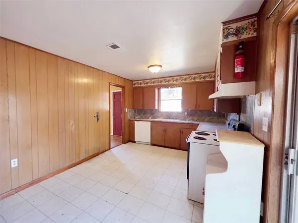 a kitchen with a refrigerator and a stove