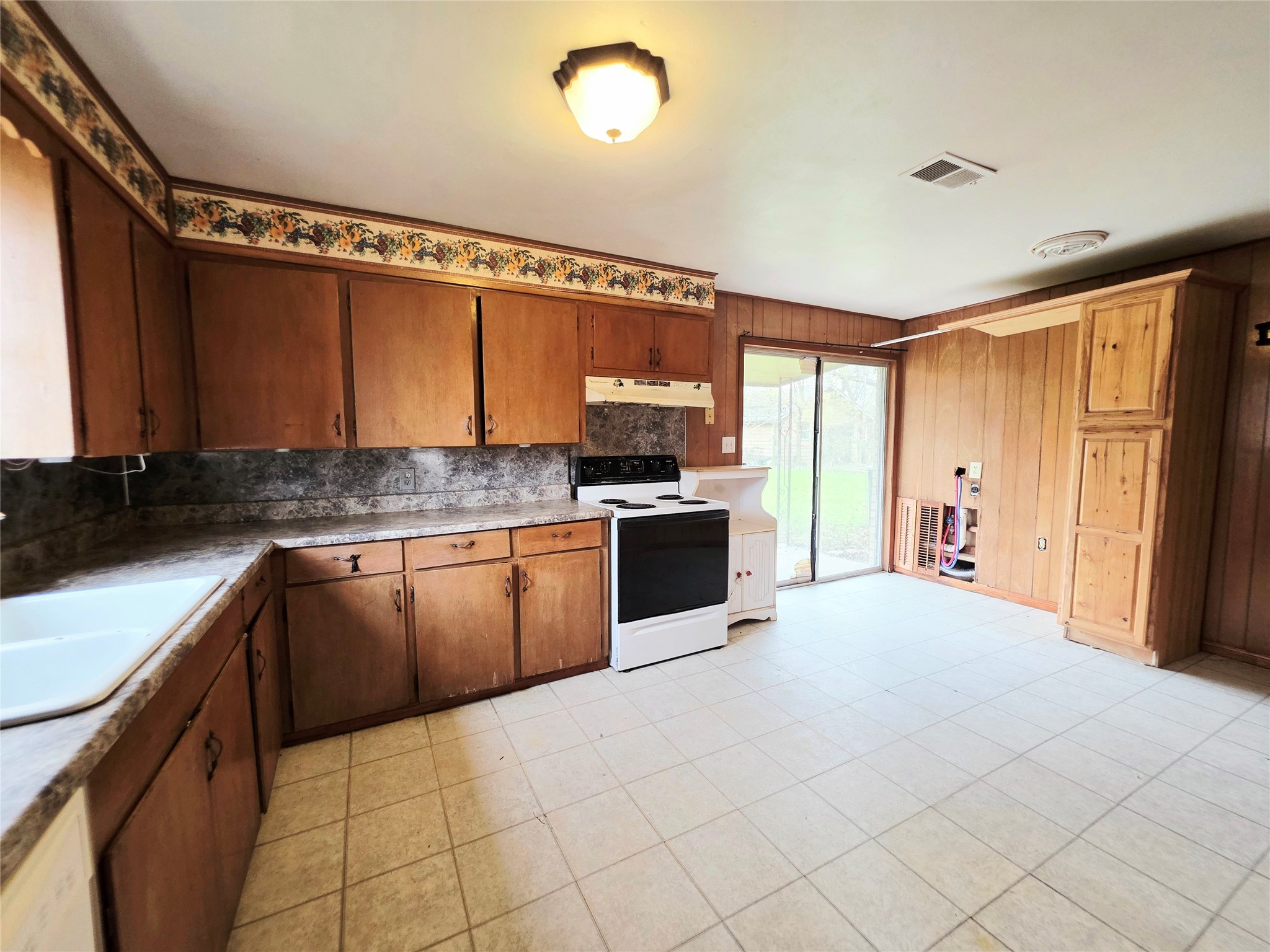111 South Harvey House Road Somerville, TX 77879 - Photo 9 of 22 a large kitchen with granite countertop a stove top oven a sink and dishwasher