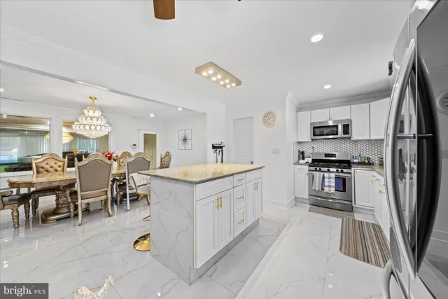 a kitchen with stainless steel appliances granite countertop a sink and cabinets