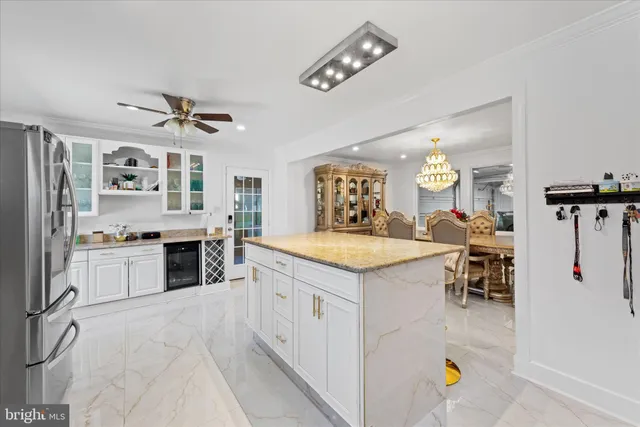 a spacious bedroom with a bed and a chandelier