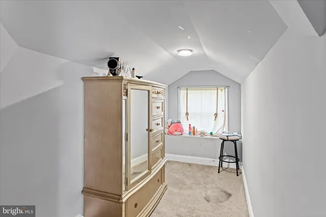 a bedroom with a bed and a large mirror