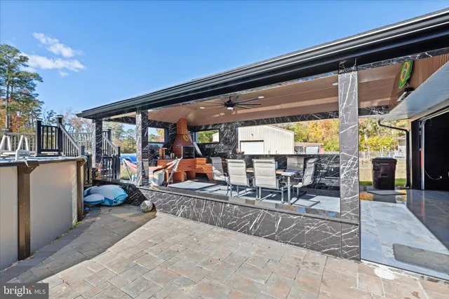 an aerial view of residential houses with outdoor space and trees