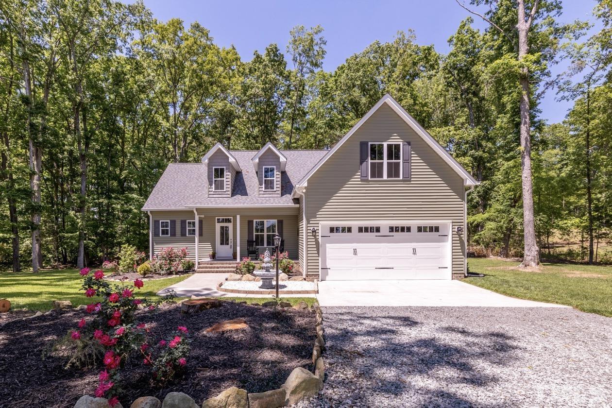 1518 Tom Oakley Road Timberlake, NC 27583 - Photo 1 of 55 a front view of a house with garden