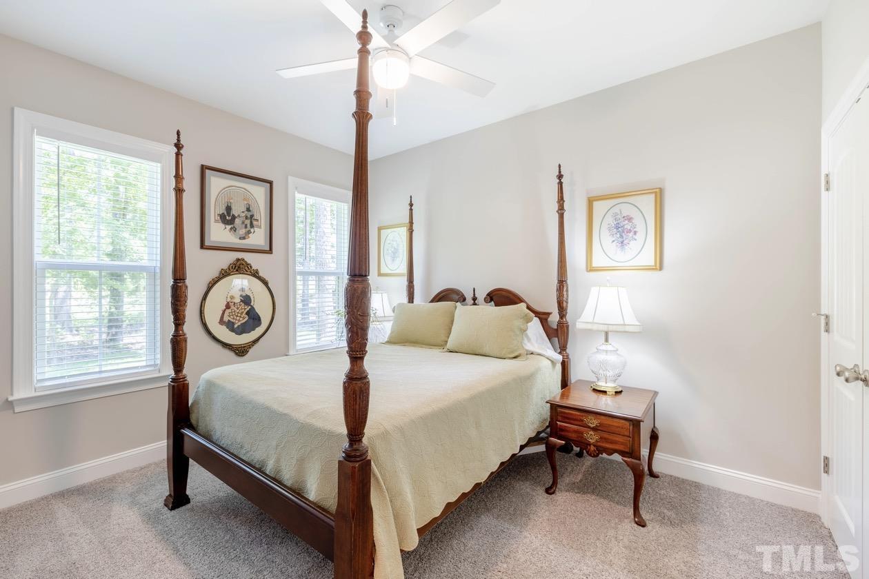 1518 Tom Oakley Road Timberlake, NC 27583 - Photo 28 of 55 a bedroom with a bed a chandelier and a window