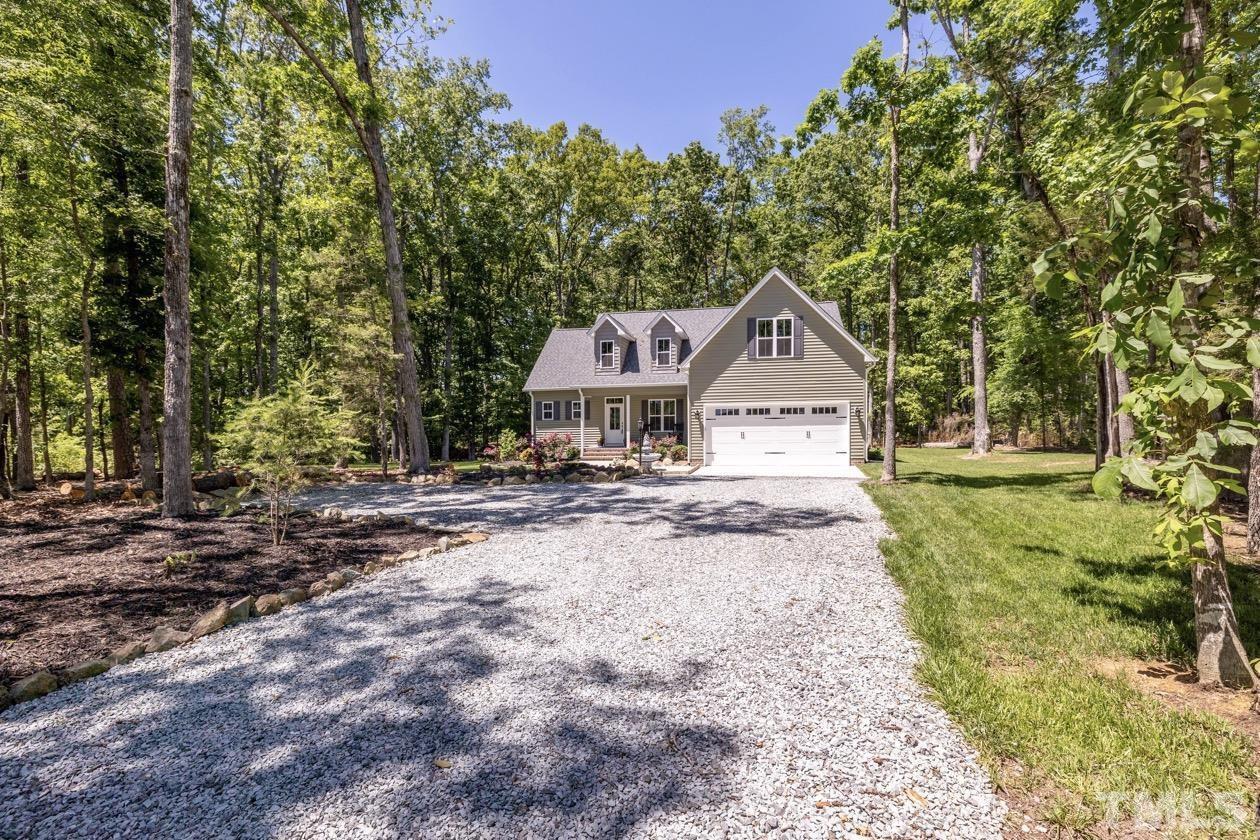 1518 Tom Oakley Road Timberlake, NC 27583 - Photo 46 of 55 a house with trees in the background