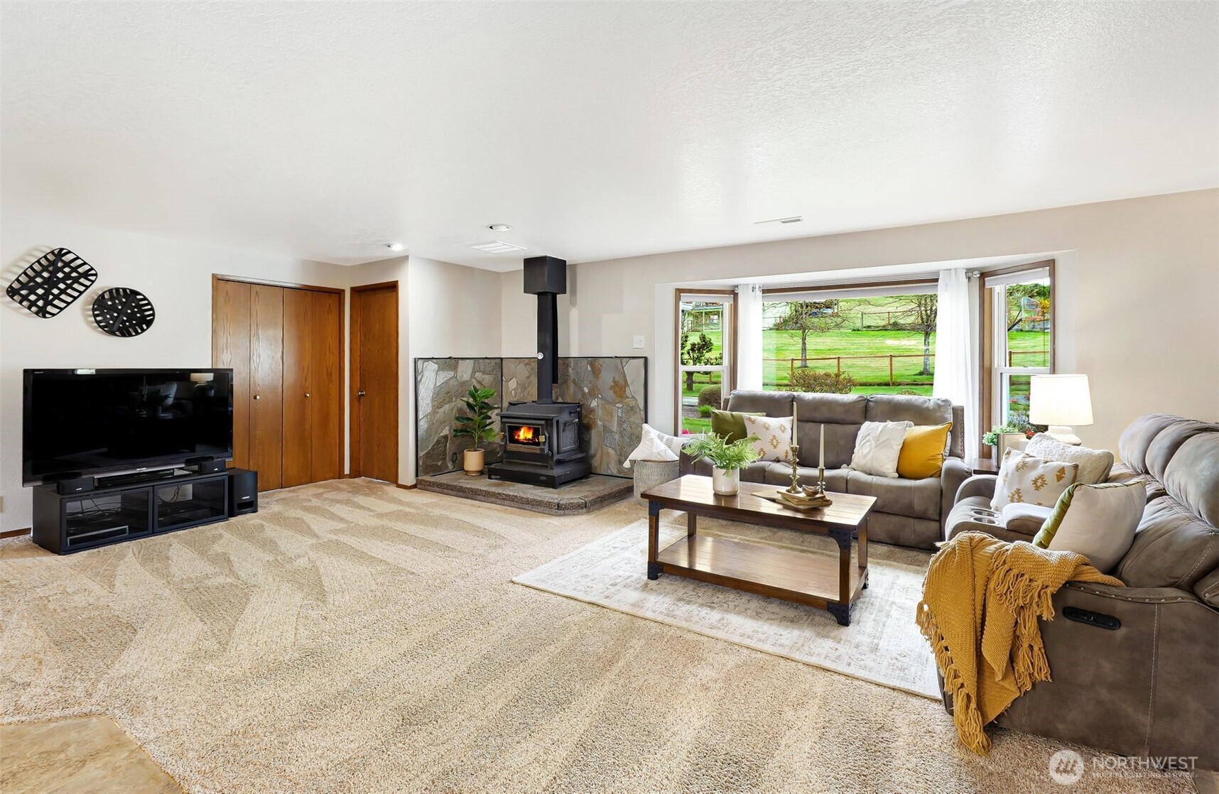 14402 Three Lakes Road Snohomish, WA 98290 - Photo 4 of 34 a living room with furniture a flat screen tv and a fireplace