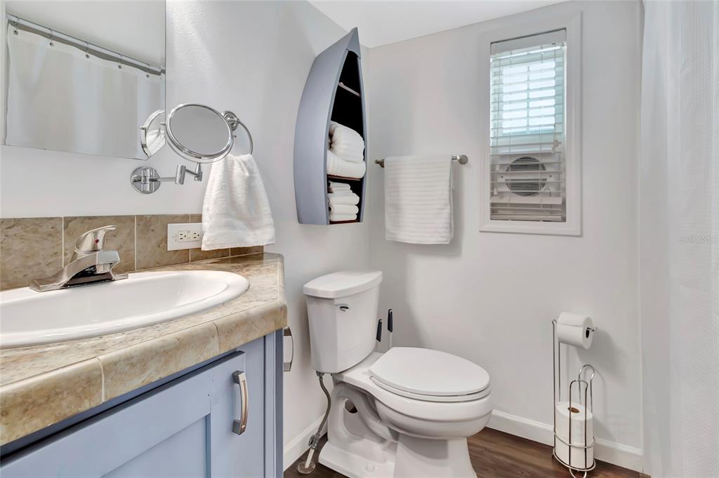 20285 Highway 27, Unit 38 Clermont, FL 34715 - Photo 11 of 33 a bathroom with a sink a toilet and mirror