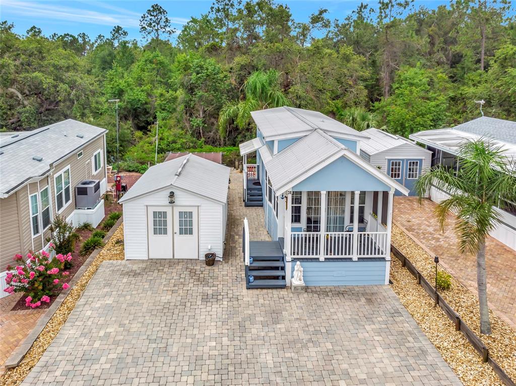 20285 Highway 27, Unit 38 Clermont, FL 34715 - Photo 2 of 33 a front view of a house with a garden