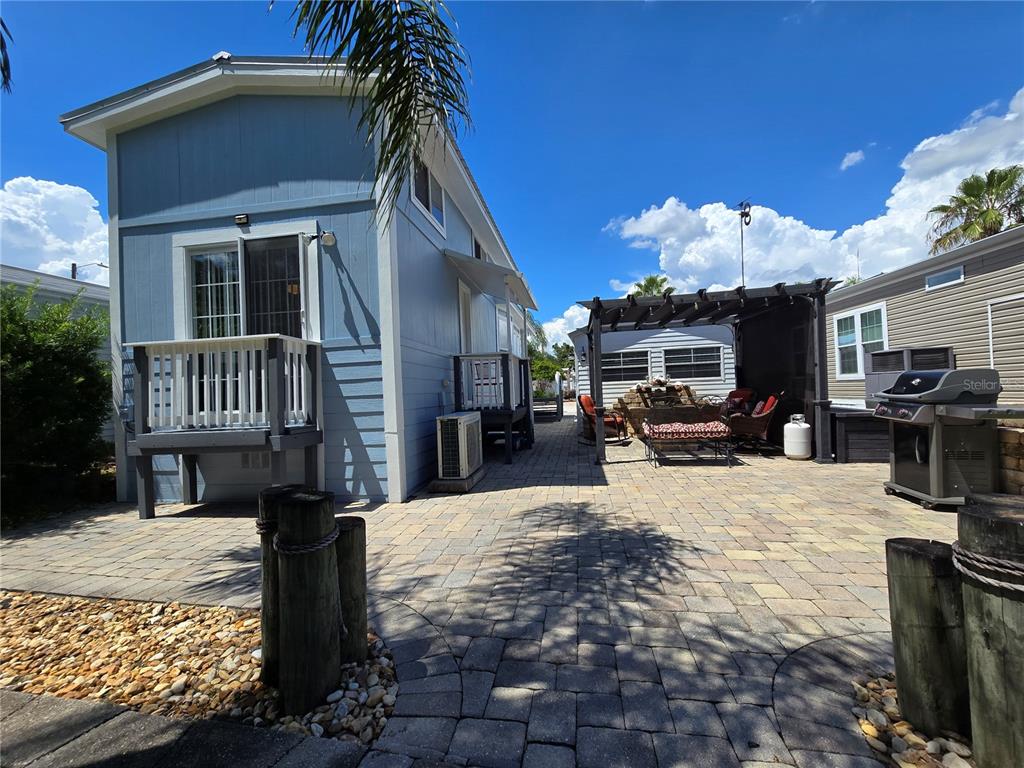 20285 Highway 27, Unit 38 Clermont, FL 34715 - Photo 22 of 33 a view of a house with backyard porch and sitting area