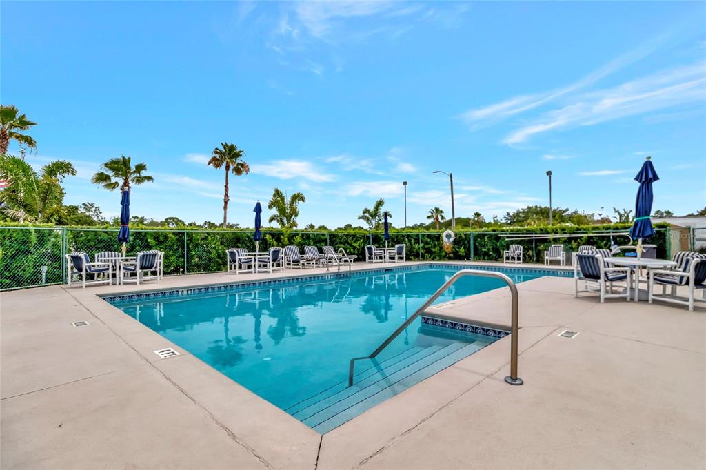 20285 Highway 27, Unit 38 Clermont, FL 34715 - Photo 32 of 33 a view of a swimming pool with outdoor seating and plants