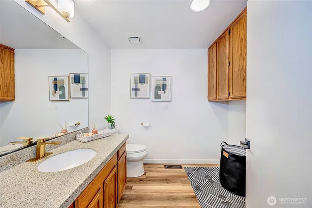 a bathroom with a granite countertop sink and a mirror
