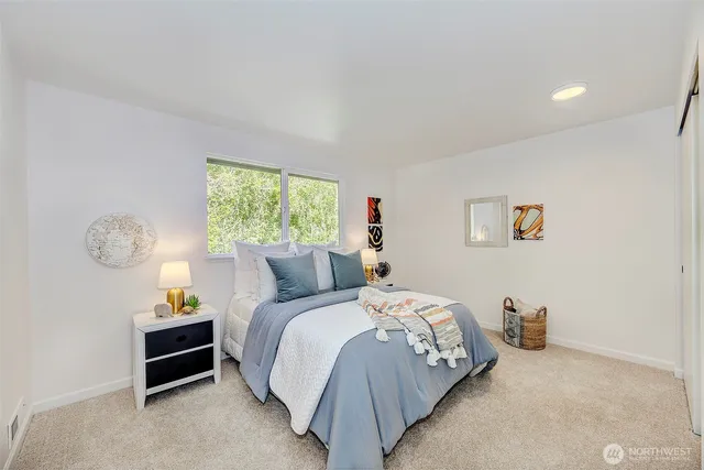 a bed room with a bed and a window