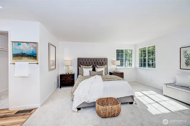 a bedroom with a bed and glass windows