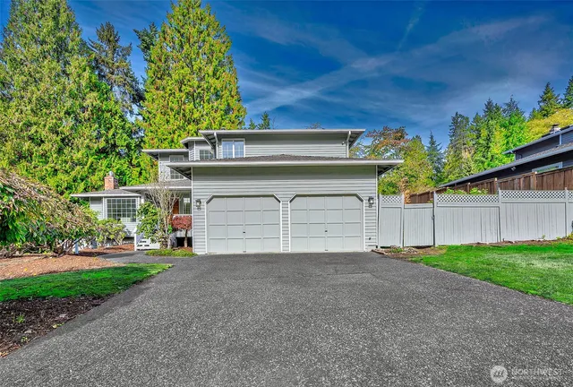 a view of a house with a yard and garage