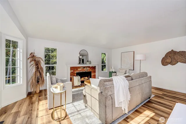 a living room with furniture a flat screen tv and a fireplace